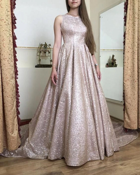 A light pink sequined sleeveless dress with a round neck design that is simple and elegant. The skirt is covered in shiny sequins and is suitable for dinners, dances, and more by YiHuiw