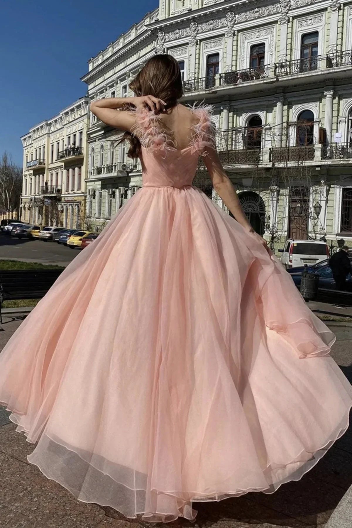Light pink dress, deep V-neck, sleeveless design, with feather accents on the shoulders by YiHuiw