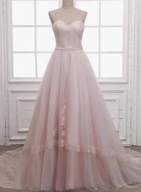 Light pink wedding dress with strapless design and sheer skirt with lace decoration by YiHuiw