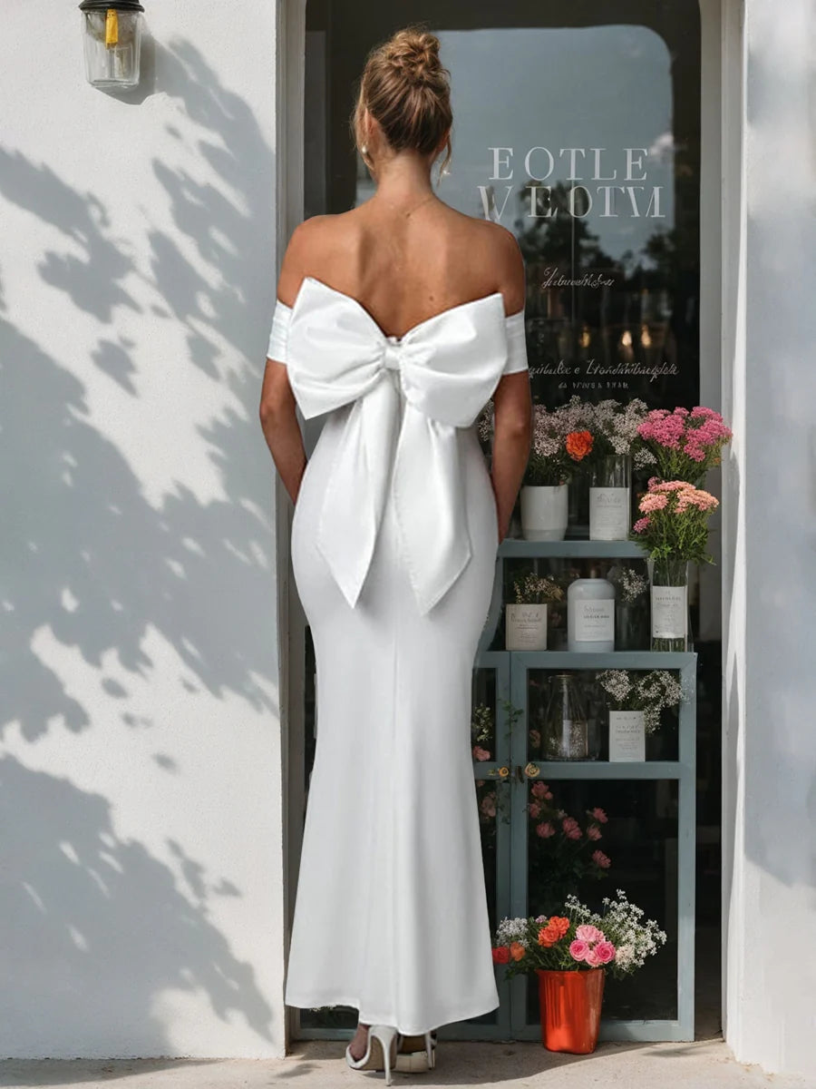 Vestido de novia de satén con hombros descubiertos, lazo extragrande removible en la espalda, silueta de sirena y bajo hasta el suelo