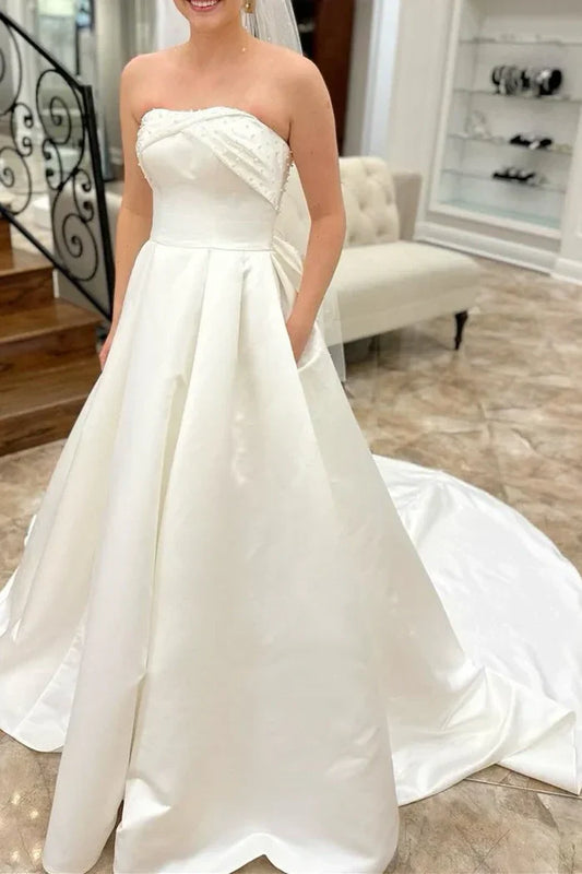 Strapless Satin Wedding Dresses with Pearl Embellishments, Oversized Back Bow, Side Pockets and Voluminous A-Line Skirt Bridal Gown