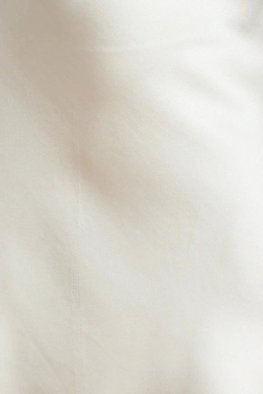 A beige hanging neck short skirt with a tie design at the neck. The skirt body is made of satin material, suitable for parties, dates, etc by YiHuiw