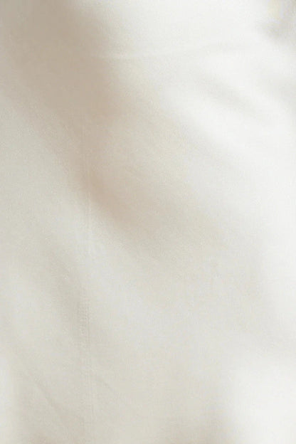A beige hanging neck short skirt with a tie design at the neck. The skirt body is made of satin material, suitable for parties, dates, etc by YiHuiw