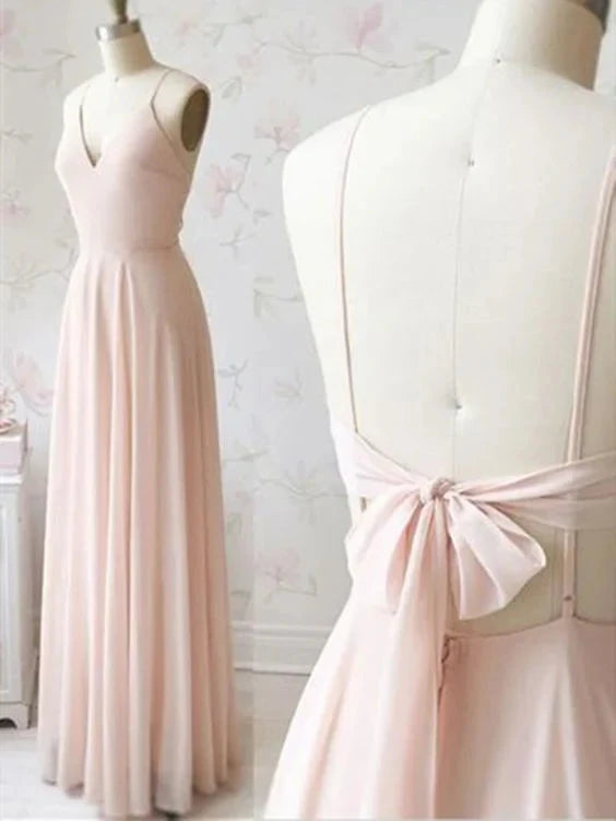 A light pink long dress with a deep V-neck strap and a bow design on the back, by YiHuiw