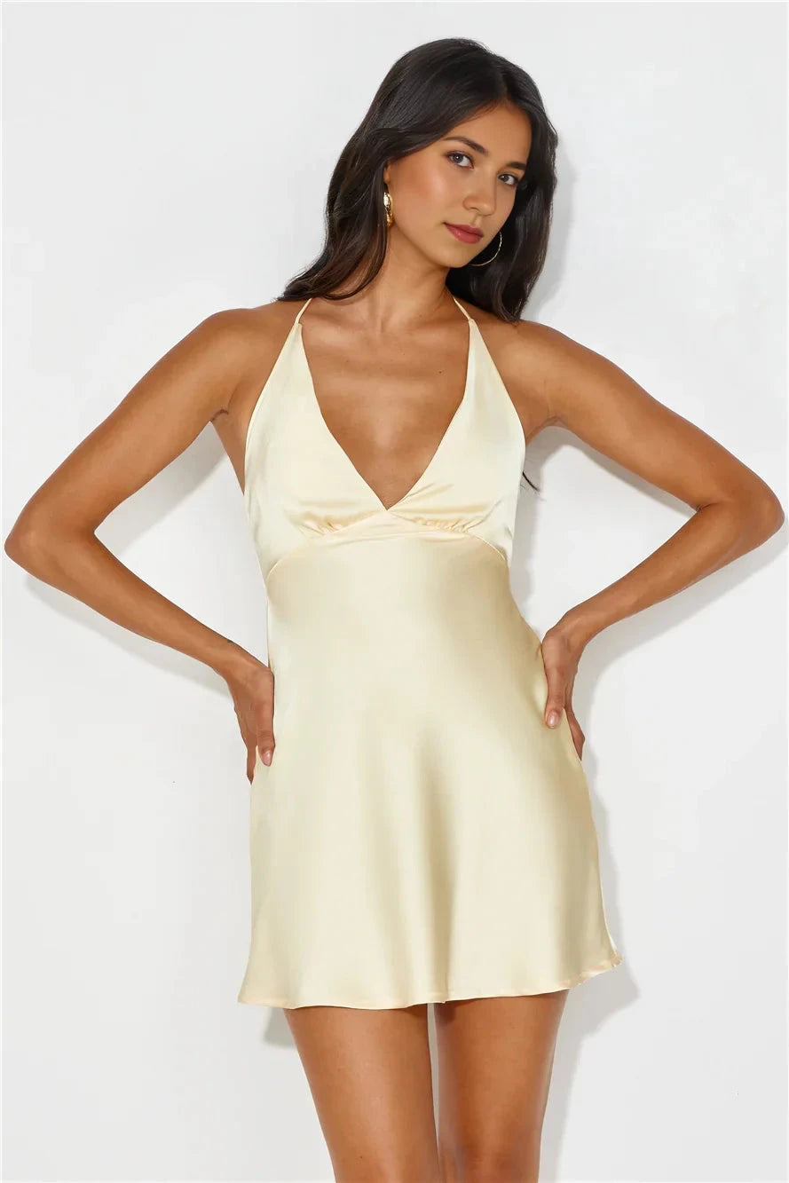 A light yellow camisole short skirt with a deep V-neck and camisole design, suitable for parties, dates, etc by YiHuiw
