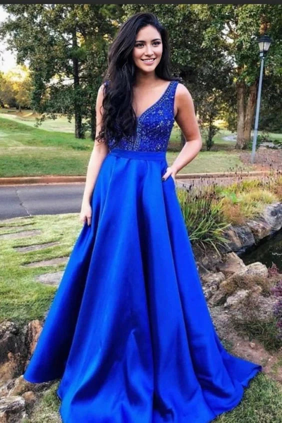 A navy blue long dress with a deep V-neck design and sparkling decorations, suitable for formal occasions such as dinners and parties by YiHuiw