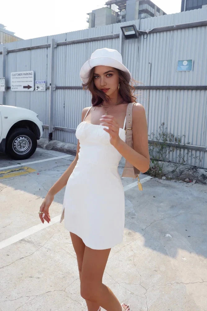 A white camisole short skirt with a thin camisole design and a slit design on the side, suitable for summer travel, dating, etc by YiHuiw
