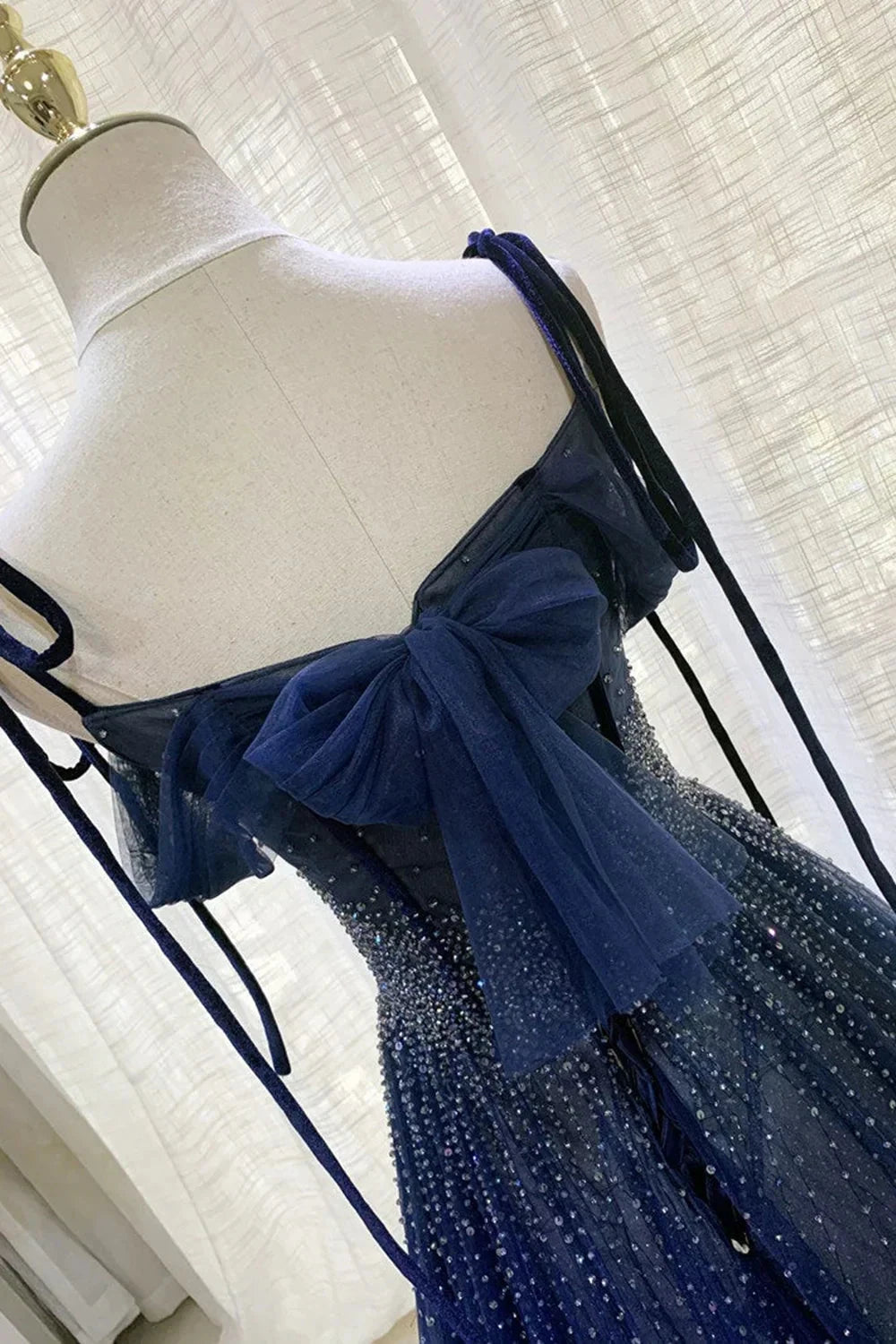 Deep blue mesh dress with suspender design and pleated nail beads embellishing the body by YiHuiw