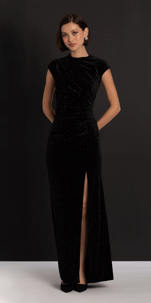 Elegant black velvet evening dress with cap sleeves, mock neck, ruched waist, and floor-length skirt with slit