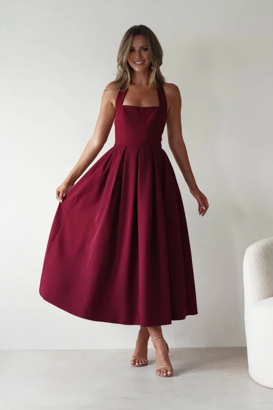 Elegant structured crepe A-line halter open-back pleated midi evening dress
