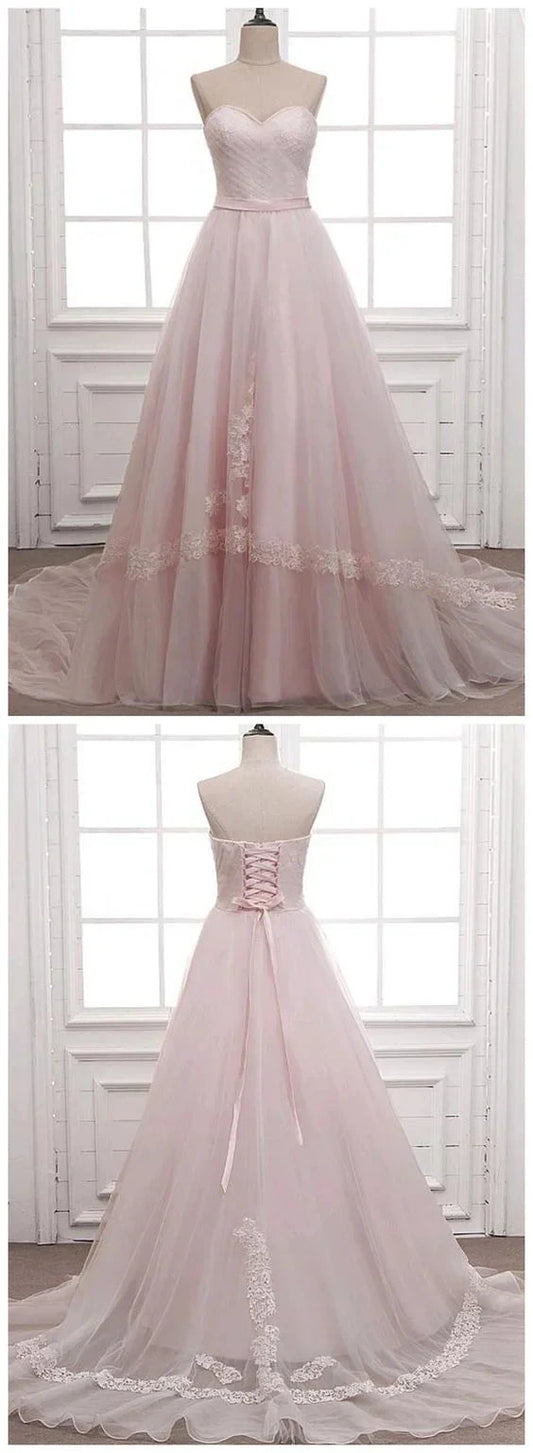 Light pink wedding dress with strapless design and sheer skirt with lace decoration by YiHuiw