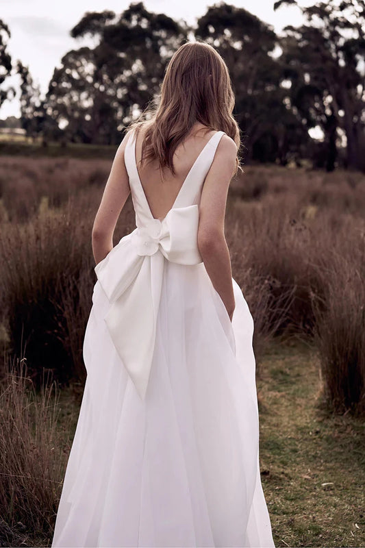 Romantic Chiffon A-Line Deep-V Open-Back Oversized-Bow Train Wedding Dress by YiHuiw