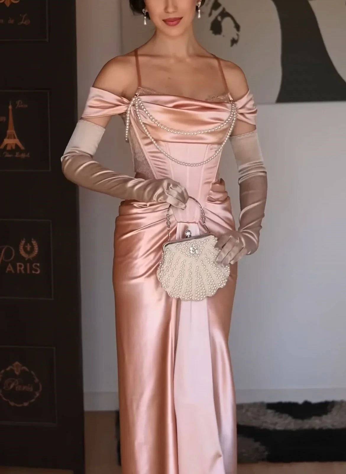 A light pink satin dress with an open shoulder strap design and a high slit skirt by YiHuiw