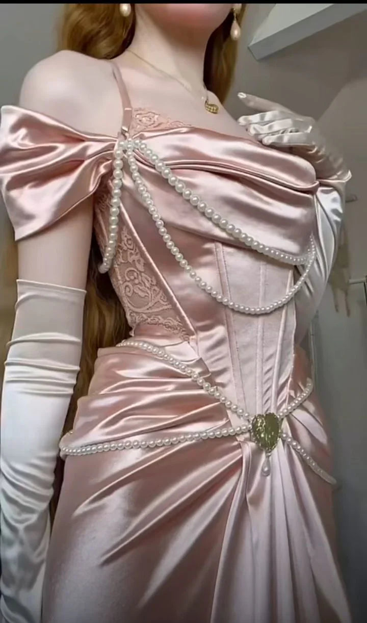 A light pink satin dress with an open shoulder strap design and a high slit skirt by YiHuiw