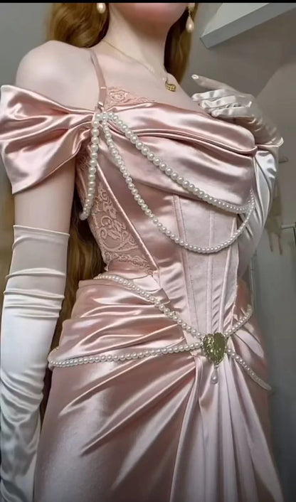 A light pink satin dress with an open shoulder strap design and a high slit skirt by YiHuiw
