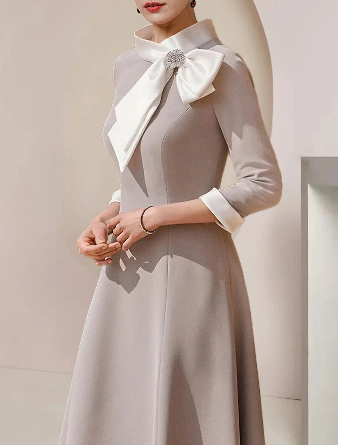A-Line Mother of the Bride Dress Formal Wedding Guest Party Elegant High Neck Asymmetrical Tea Length Satin 3/4 Length Sleeve with Bow(s) Crystal Brooch by YiHuiw